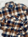 Buffalo check pattern in brown, navy, and cream shirt